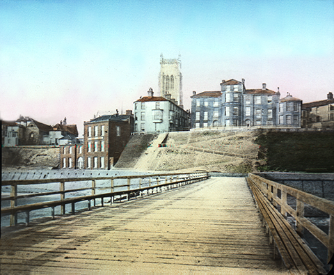 Cromer jetty, about 1880. Cromer, on an exposed coastline, has had jetties and piers from medieval times. This view looks up towards the original Hotel de Paris, on the clifftop.